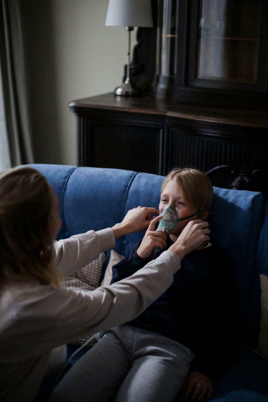 A parent helping a child with a nebulizer
