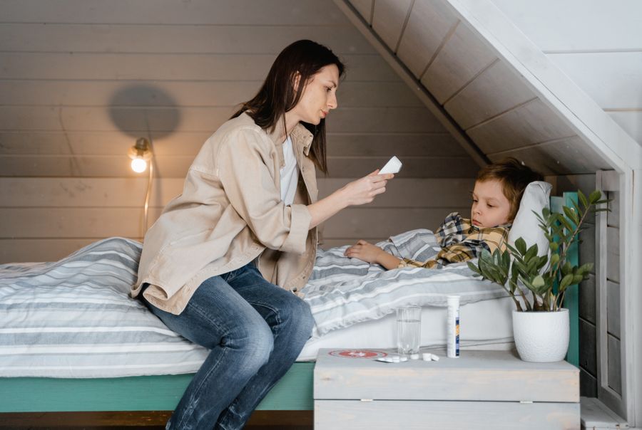 A parent checking a child's temperature