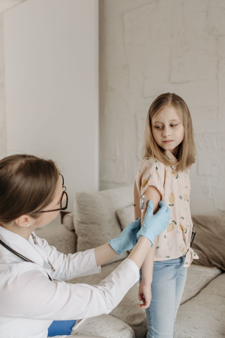 A girl getting a vaccine and a bandage